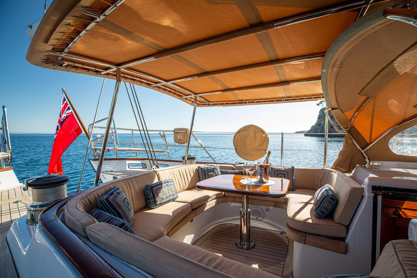 a boat with a flag on the deck aboard LEGEND Yacht for Sale