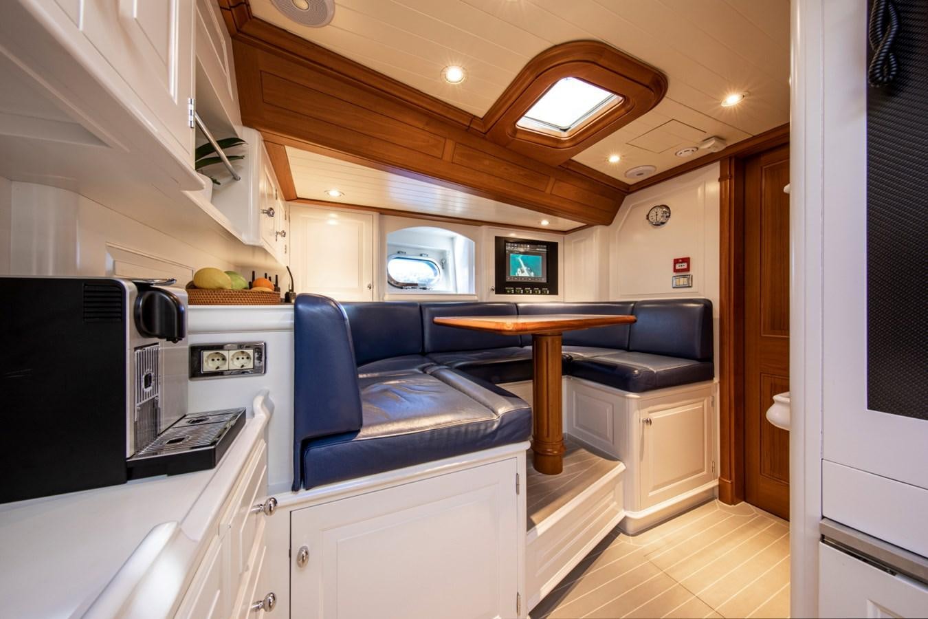 a kitchen with a dining table aboard LEGEND Yacht for Sale