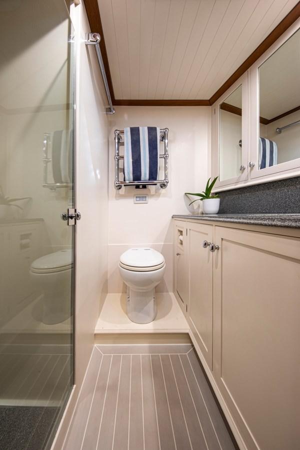 a bathroom with a toilet and a sink aboard LEGEND Yacht for Sale