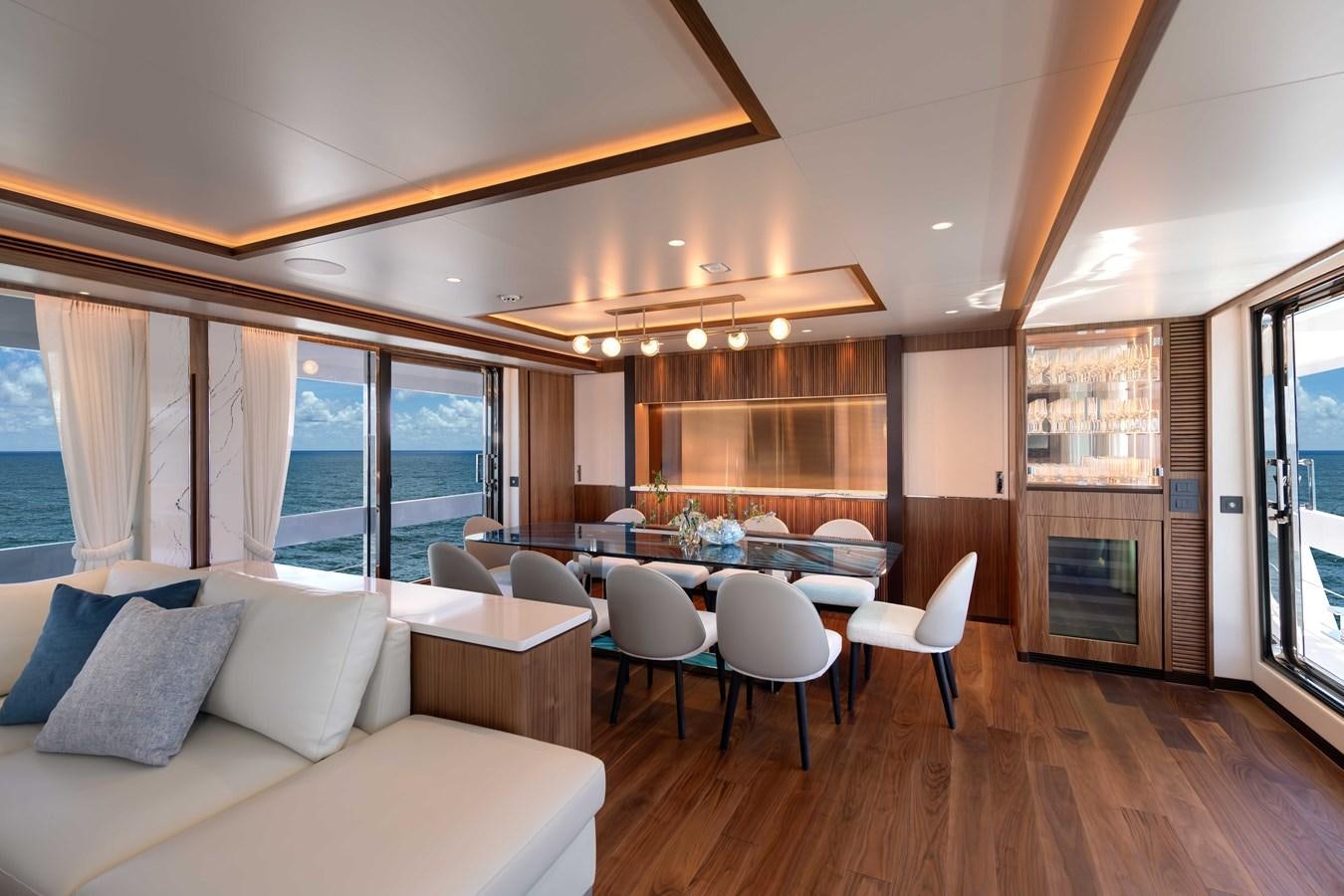 a living room with a large table and chairs aboard HORIZON FD100/911 Yacht for Sale