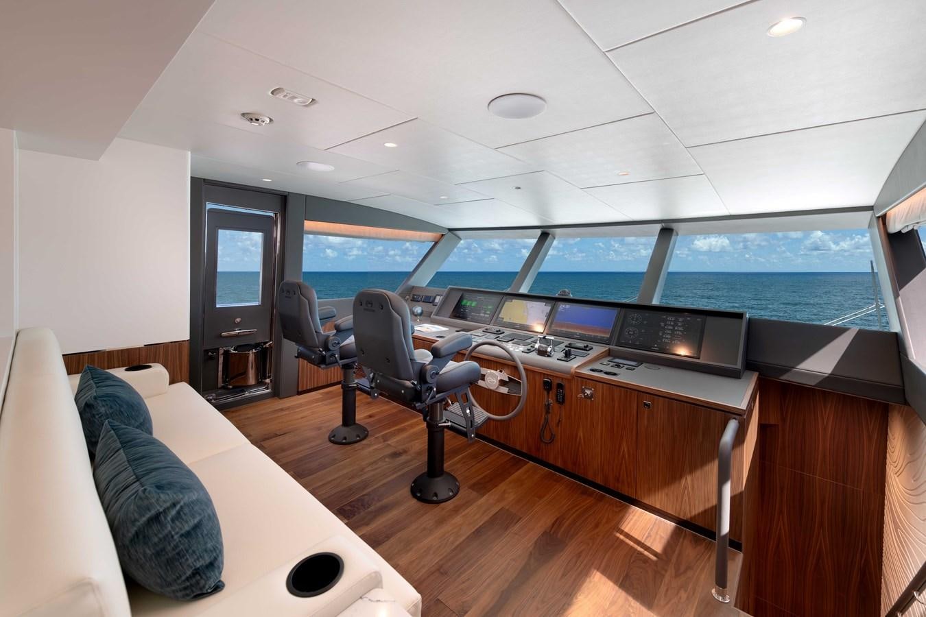 a room with a view of the ocean and the deck aboard HORIZON FD100/911 Yacht for Sale
