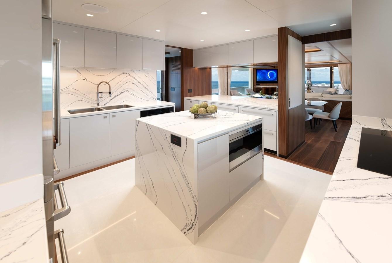 a kitchen with white cabinets aboard HORIZON FD100/911 Yacht for Sale