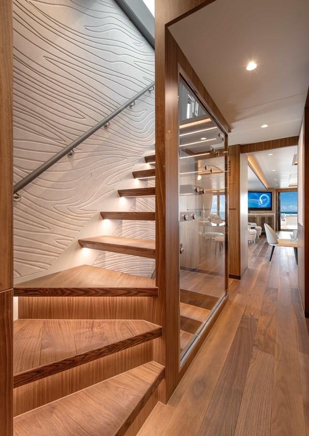 a wood staircase in a building aboard HORIZON FD100/911 Yacht for Sale