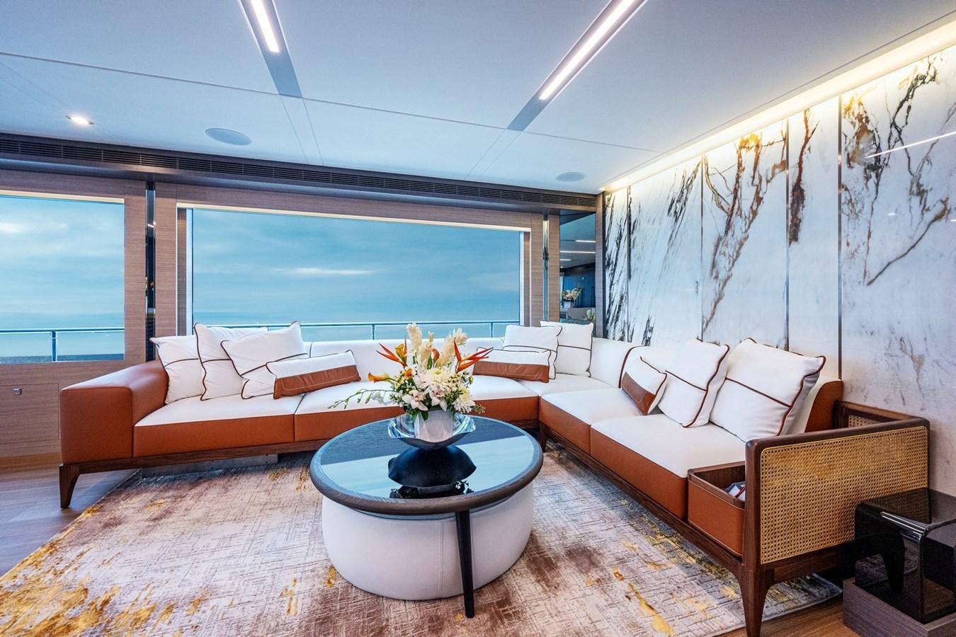 a living room with a table and couches aboard FD75-709 / NOW AVAILABLE Yacht for Sale