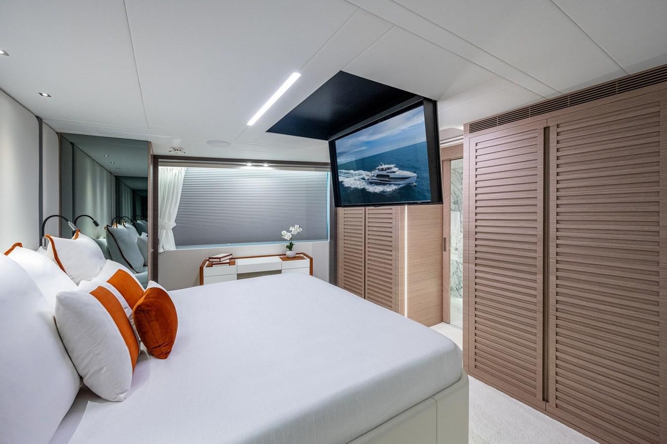 a room with a bed and a television aboard FD75-709 / NOW AVAILABLE Yacht for Sale