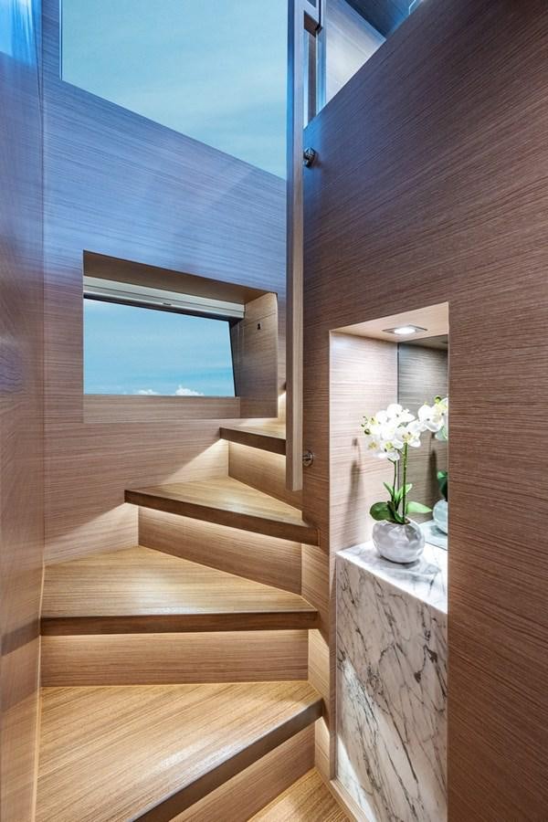 a wood stair case with white flowers aboard FD75-709 / NOW AVAILABLE Yacht for Sale