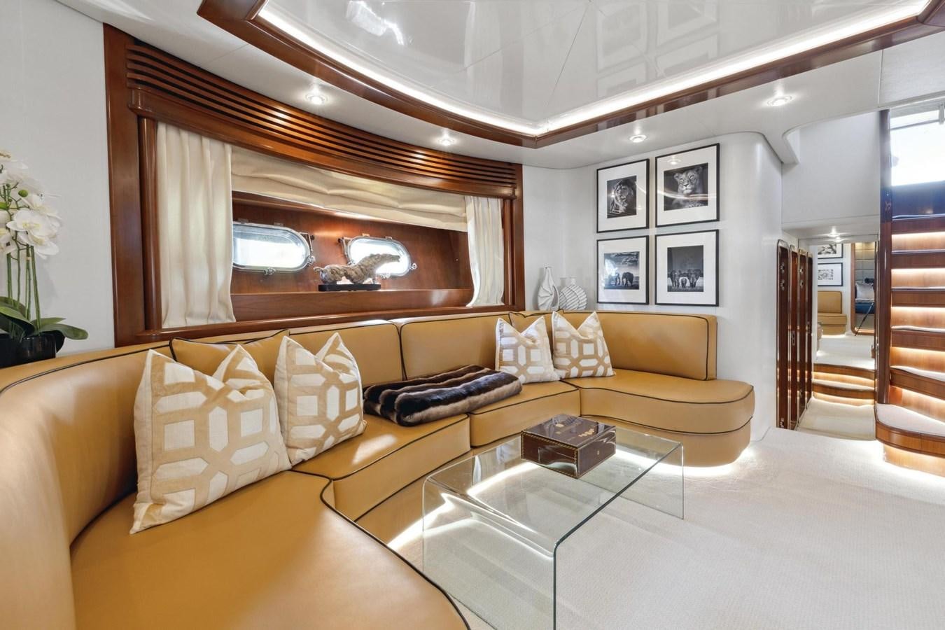 a living room with a glass coffee table and a couch aboard ALCHEMY Yacht for Sale