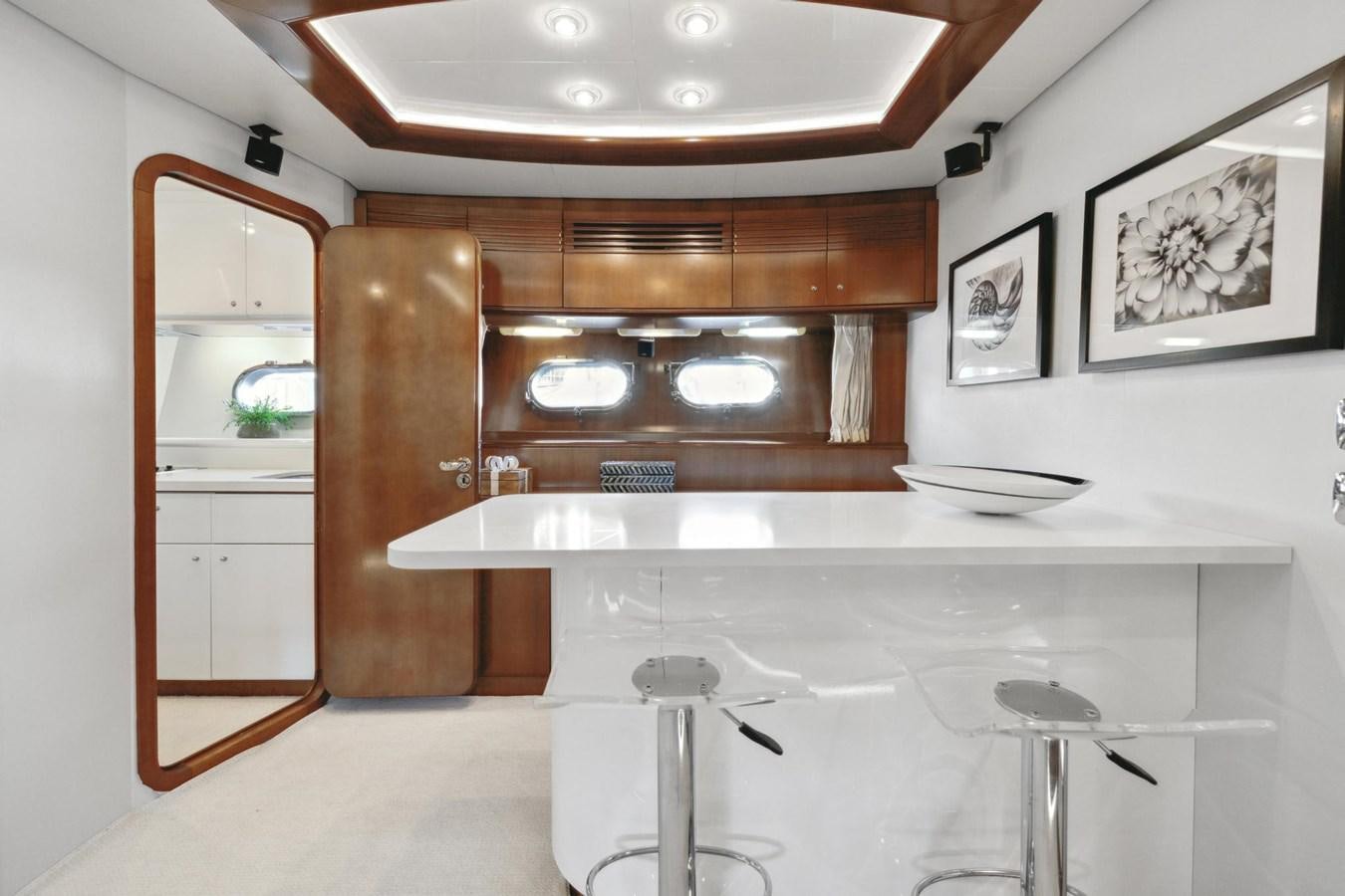 a kitchen with a bar and a table aboard ALCHEMY Yacht for Sale