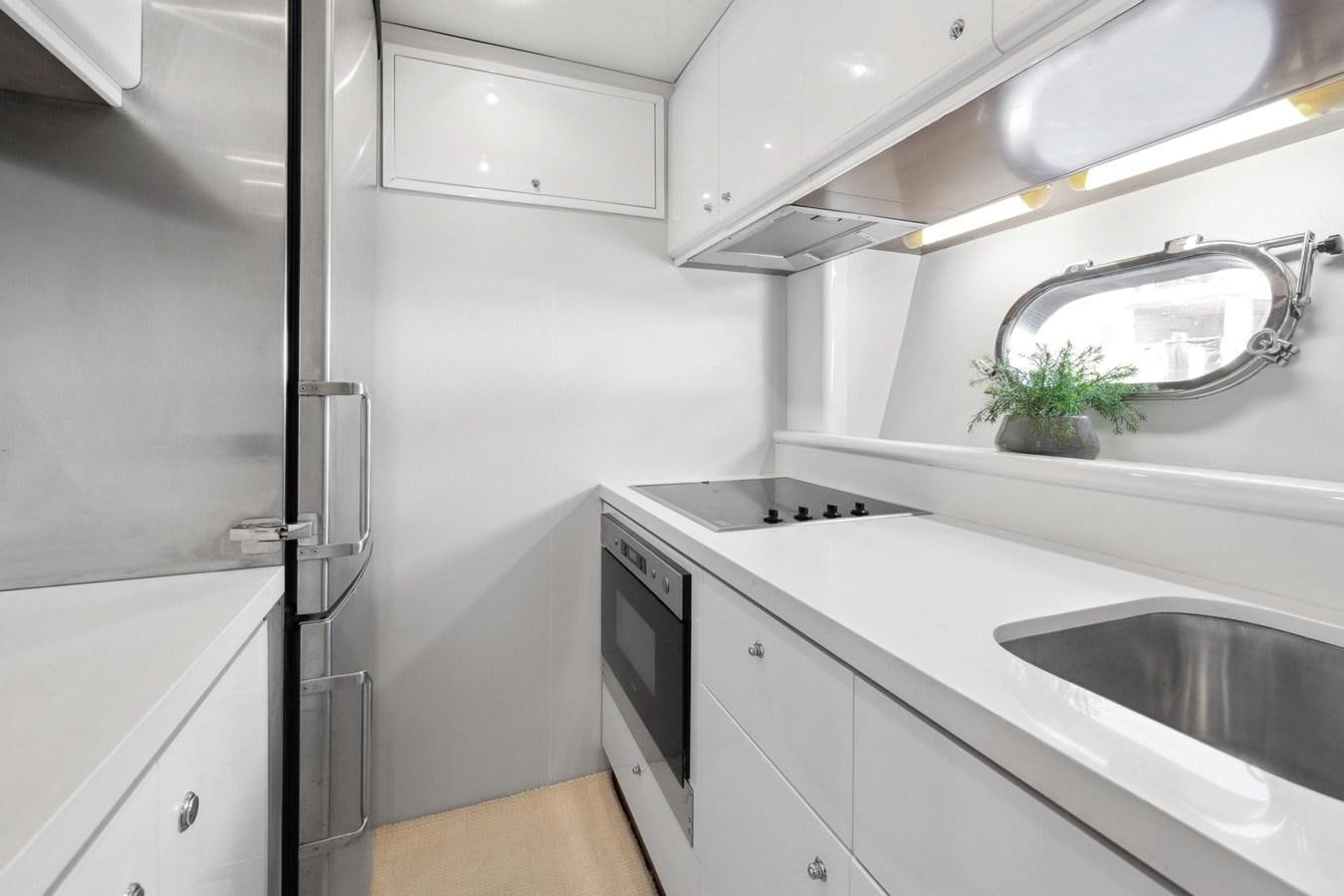 a kitchen with white cabinets aboard ALCHEMY Yacht for Sale