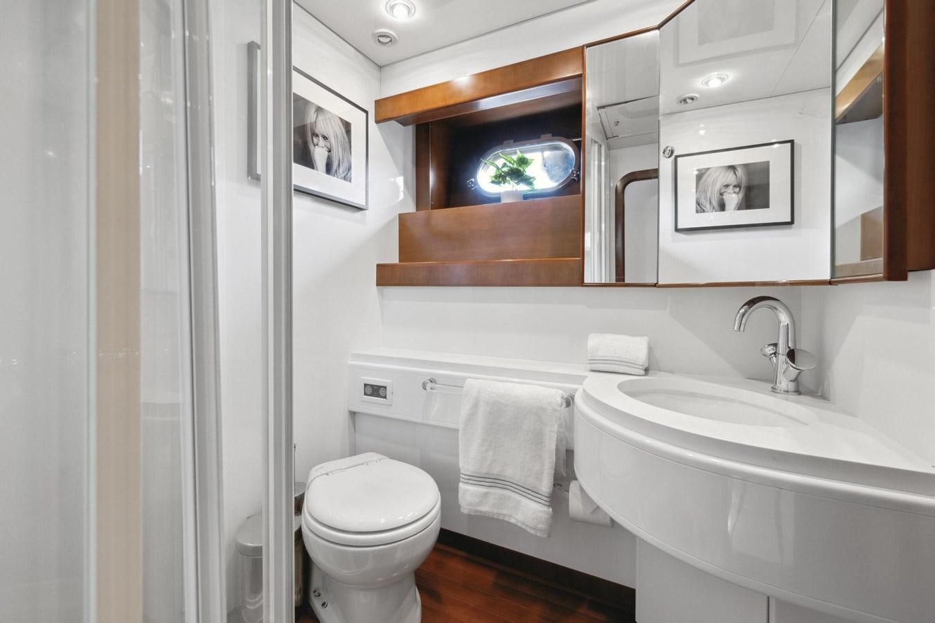 a bathroom with a sink toilet and a mirror aboard ALCHEMY Yacht for Sale