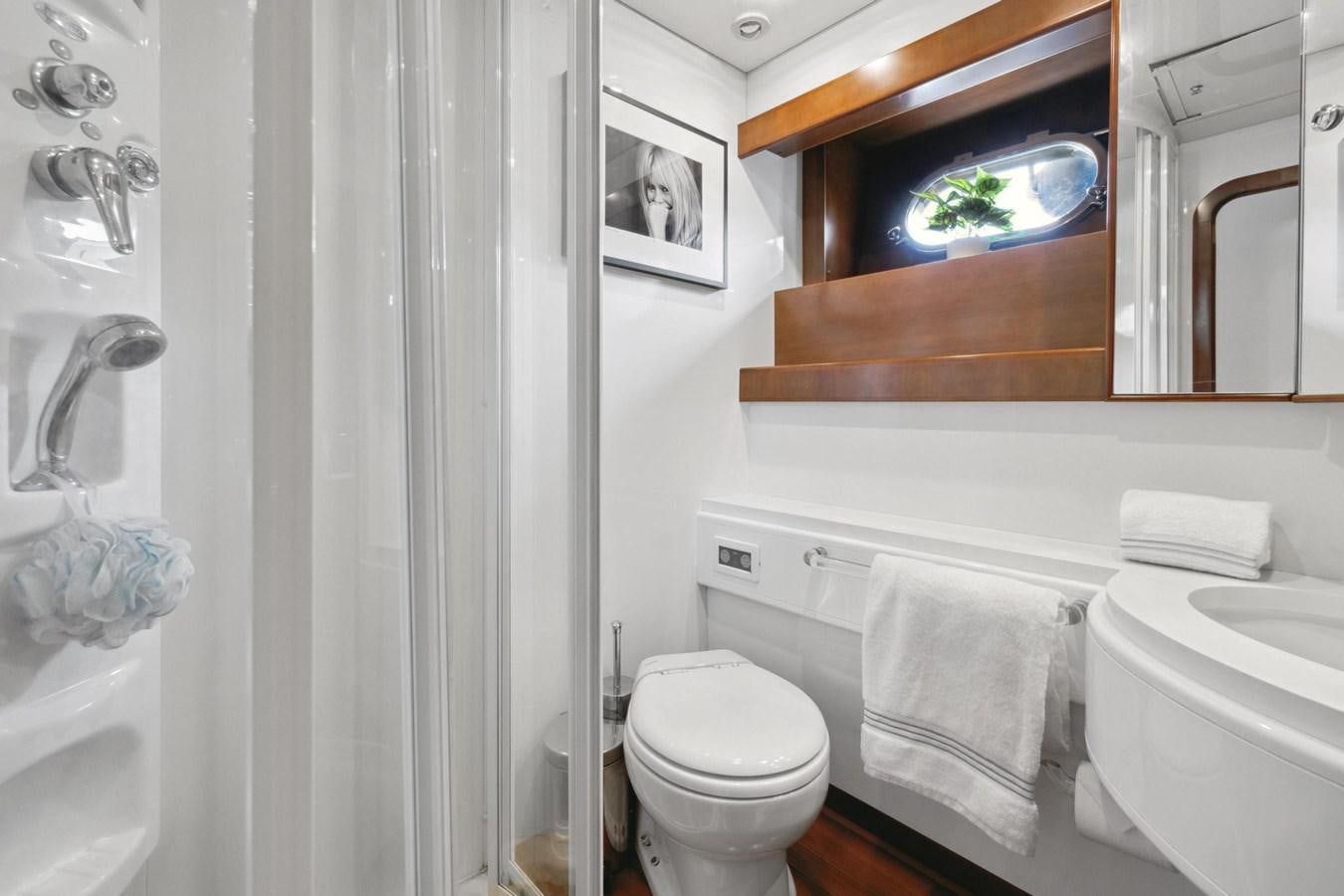 a bathroom with a toilet and a sink aboard ALCHEMY Yacht for Sale