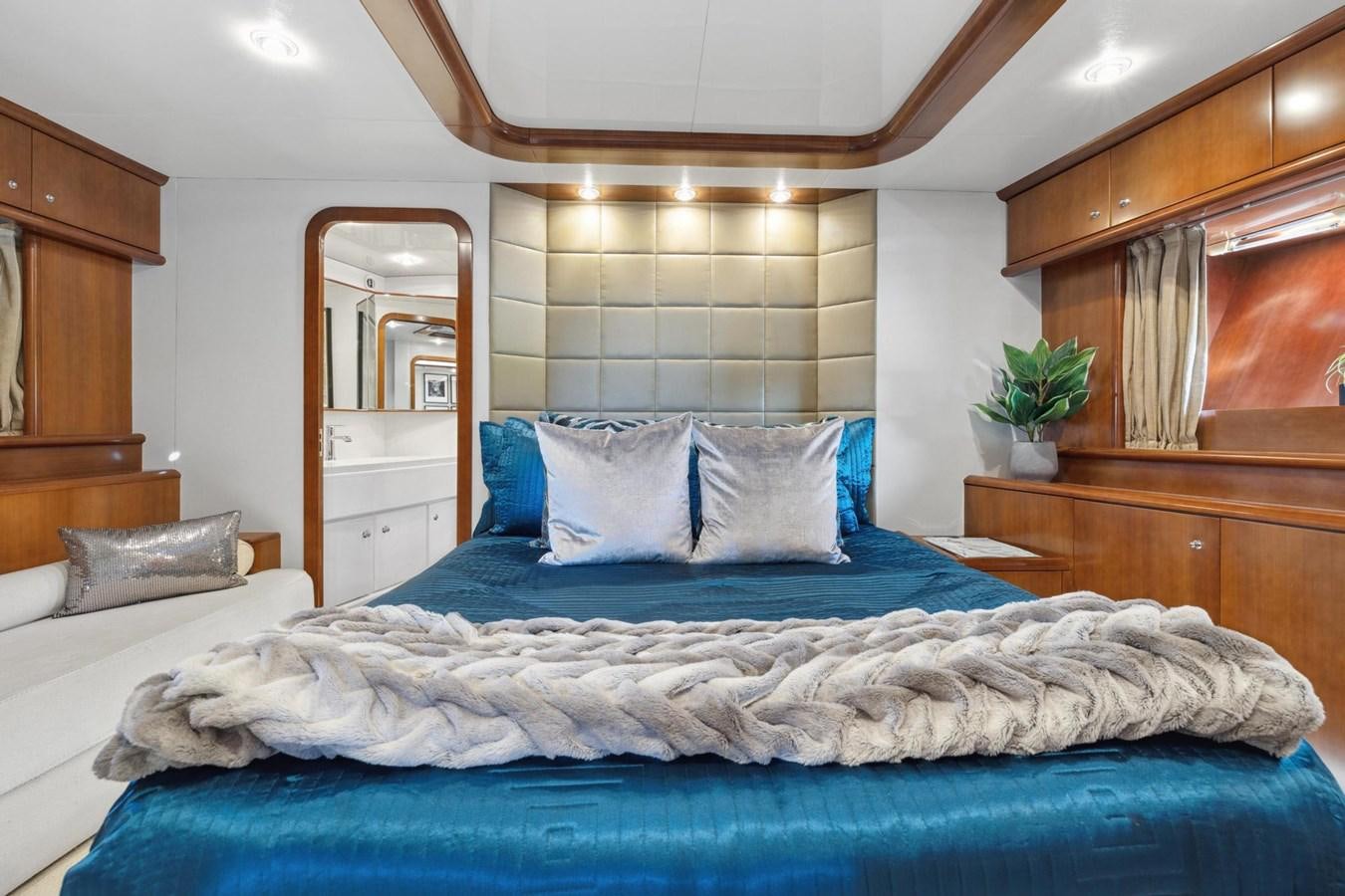 a bed with blue sheets aboard ALCHEMY Yacht for Sale
