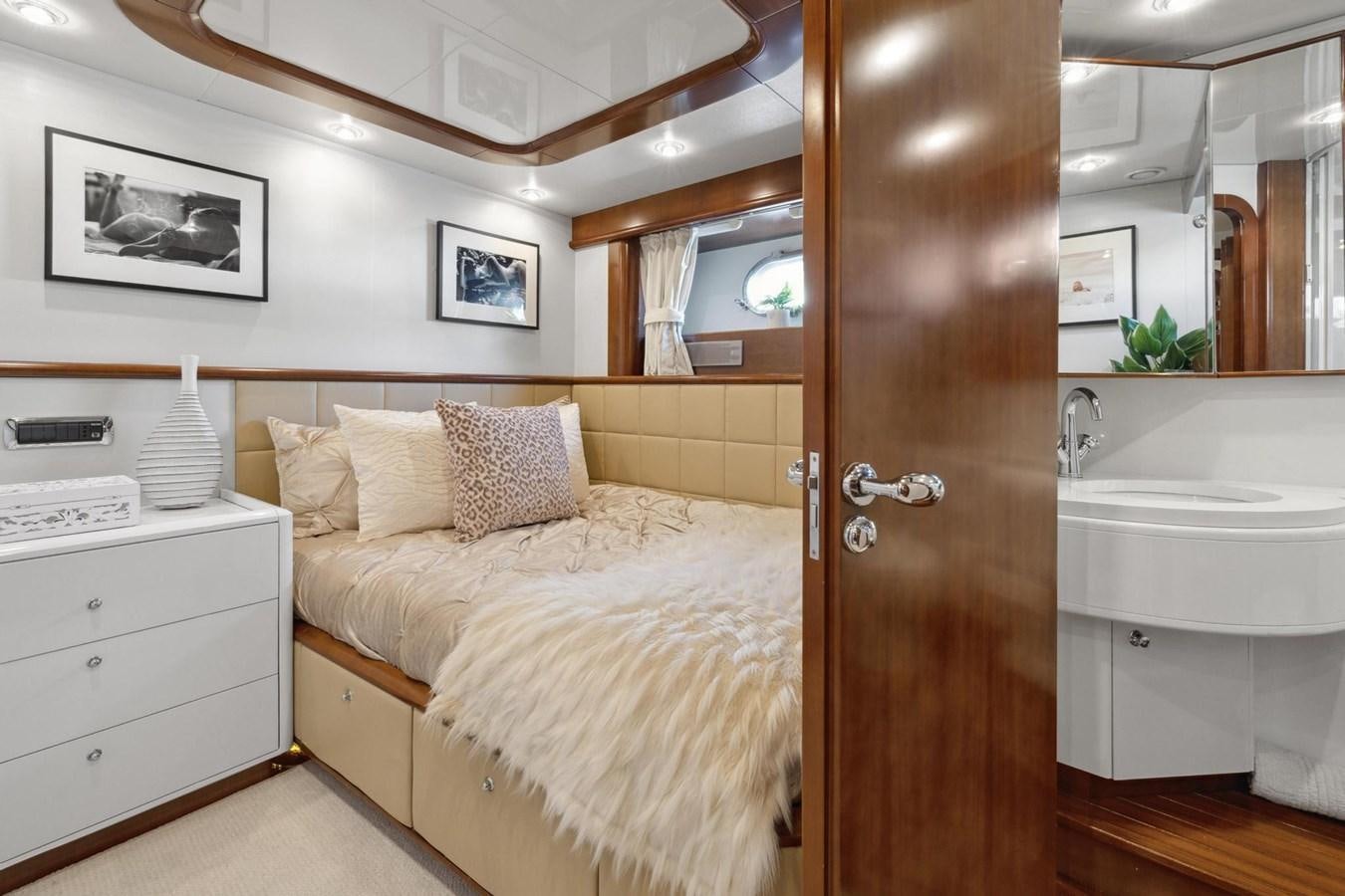 a bedroom with a bed and a sink aboard ALCHEMY Yacht for Sale