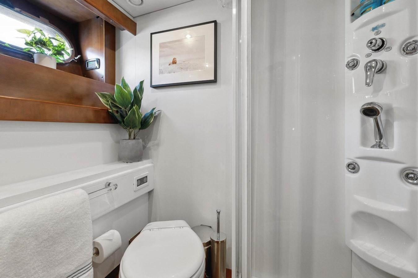 a bathroom with a toilet and a sink aboard ALCHEMY Yacht for Sale