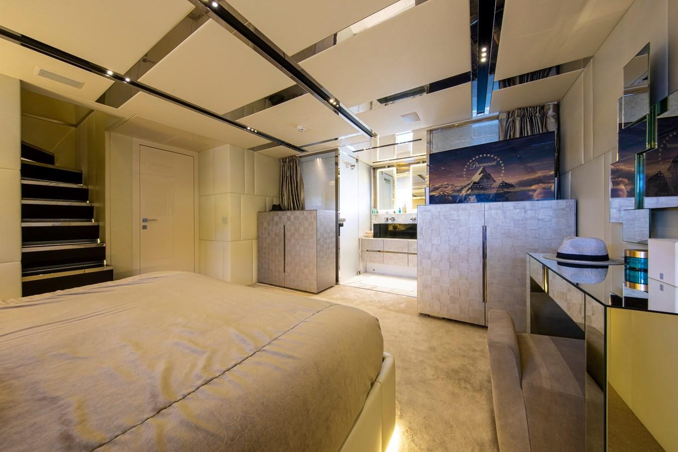 a bedroom with a bed and desk aboard CINQUANTA-50 Yacht for Sale