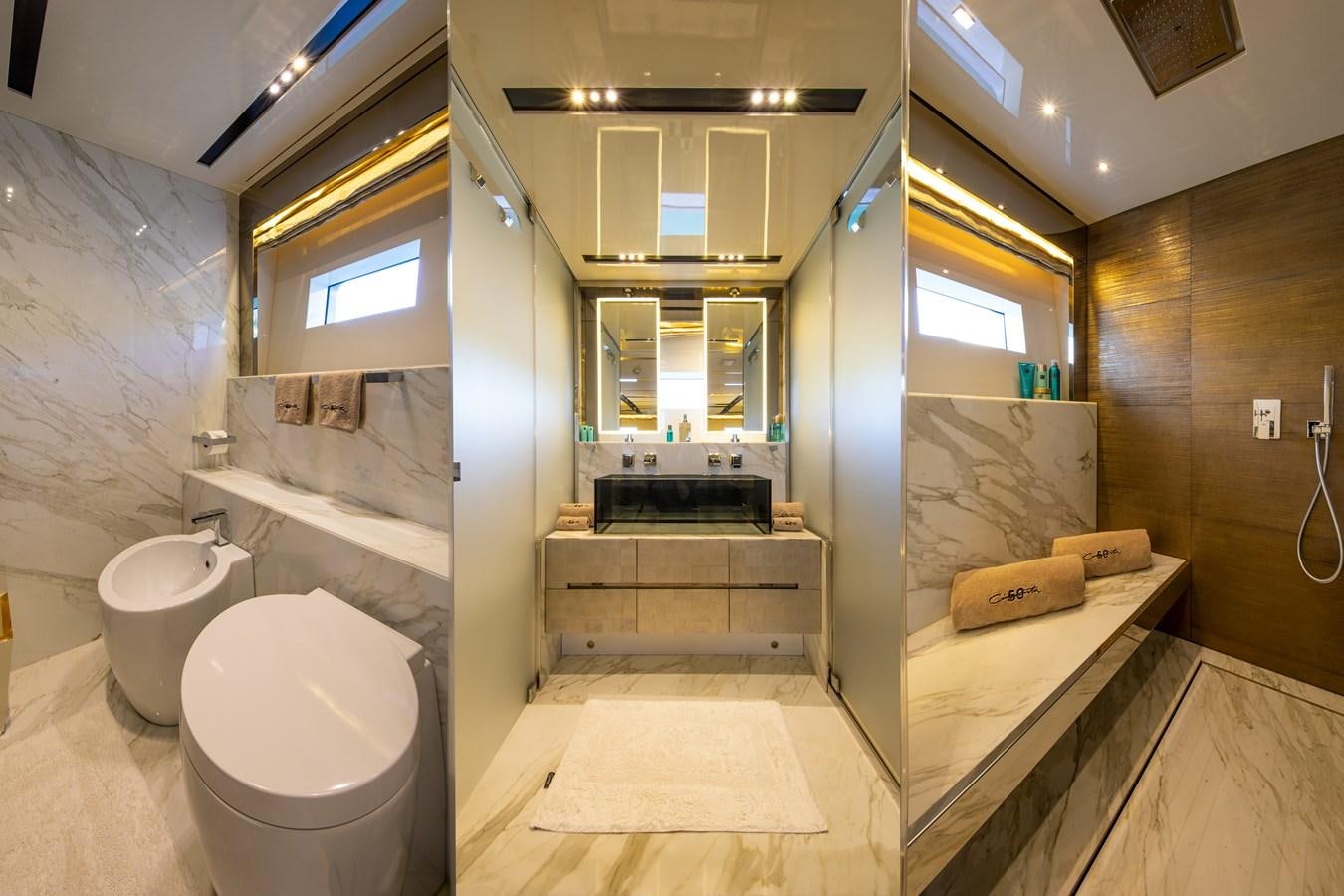 a bathroom with a toilet and a sink aboard CINQUANTA-50 Yacht for Sale