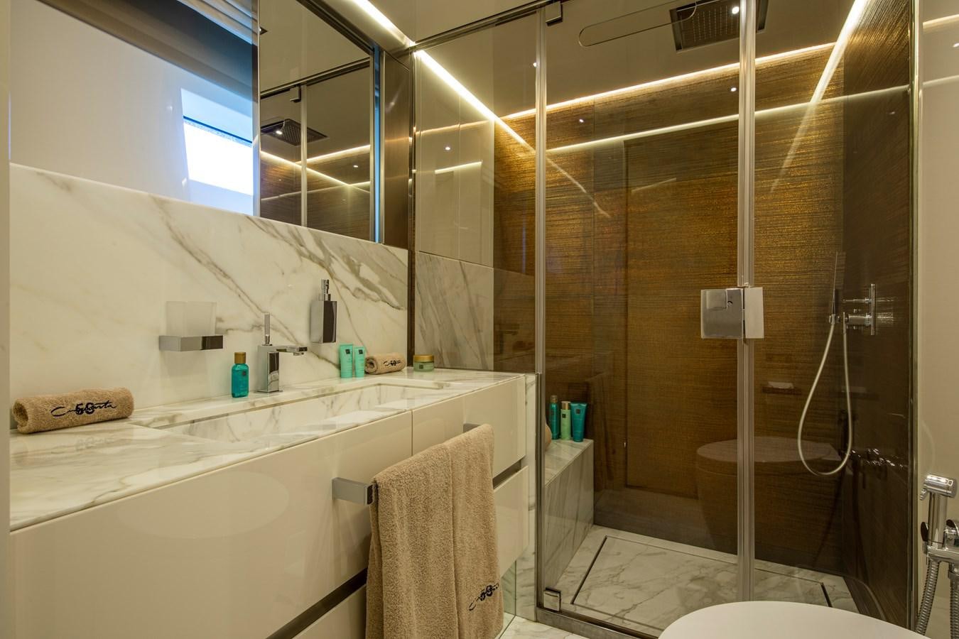 a bathroom with a glass shower aboard CINQUANTA-50 Yacht for Sale