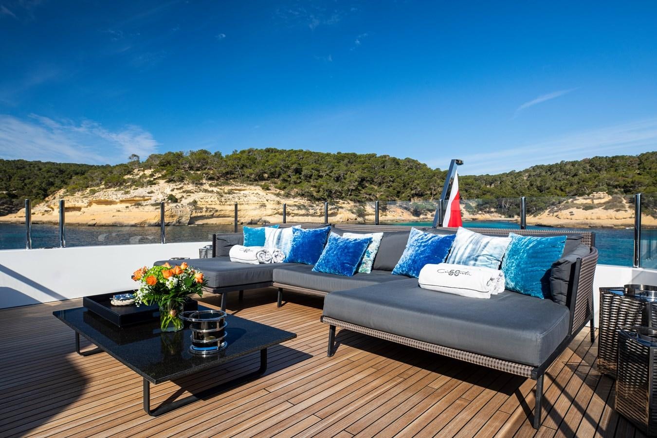 a large blue couch with a white pillow on it aboard CINQUANTA-50 Yacht for Sale