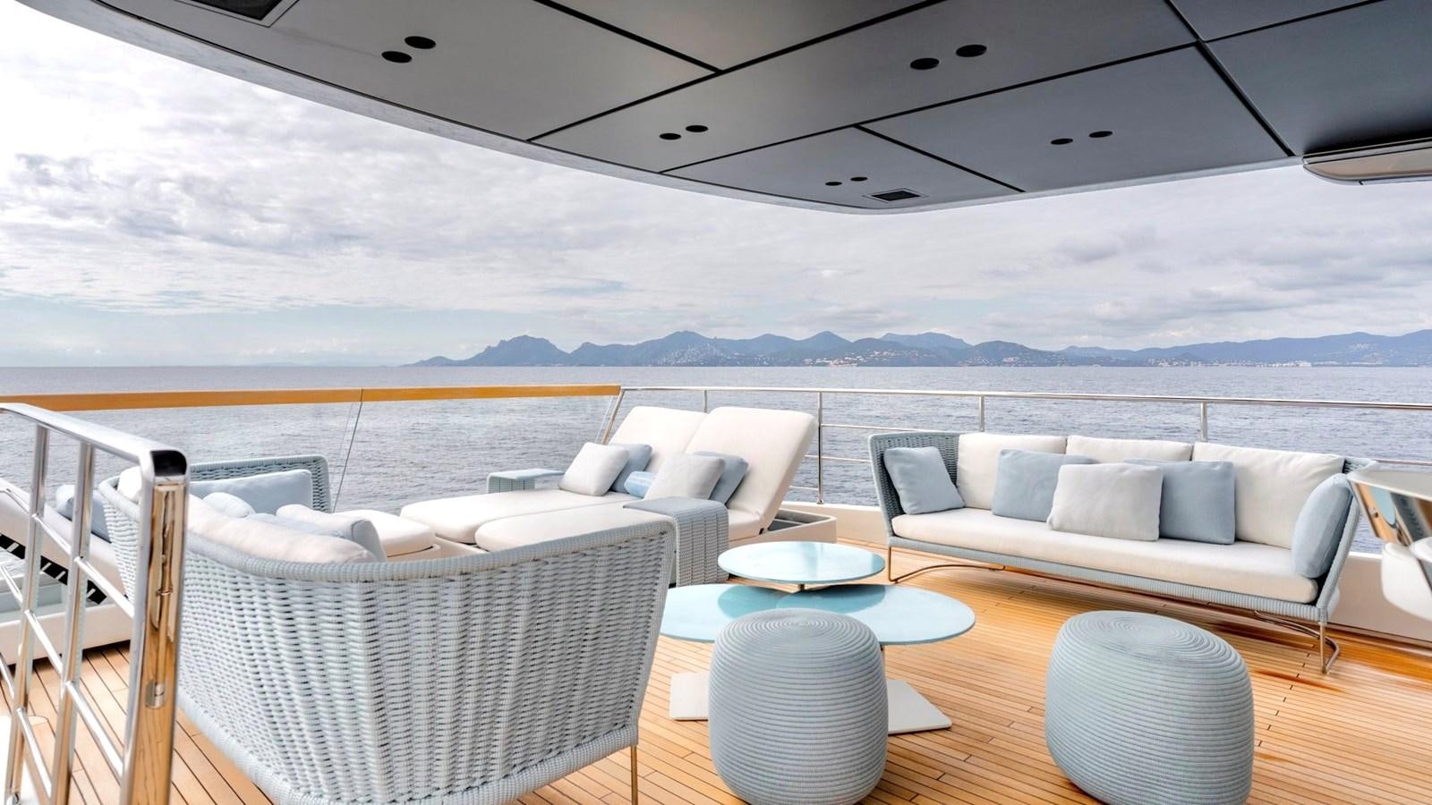 a room with a table chairs and a large body of water aboard TOGETHER Yacht for Sale