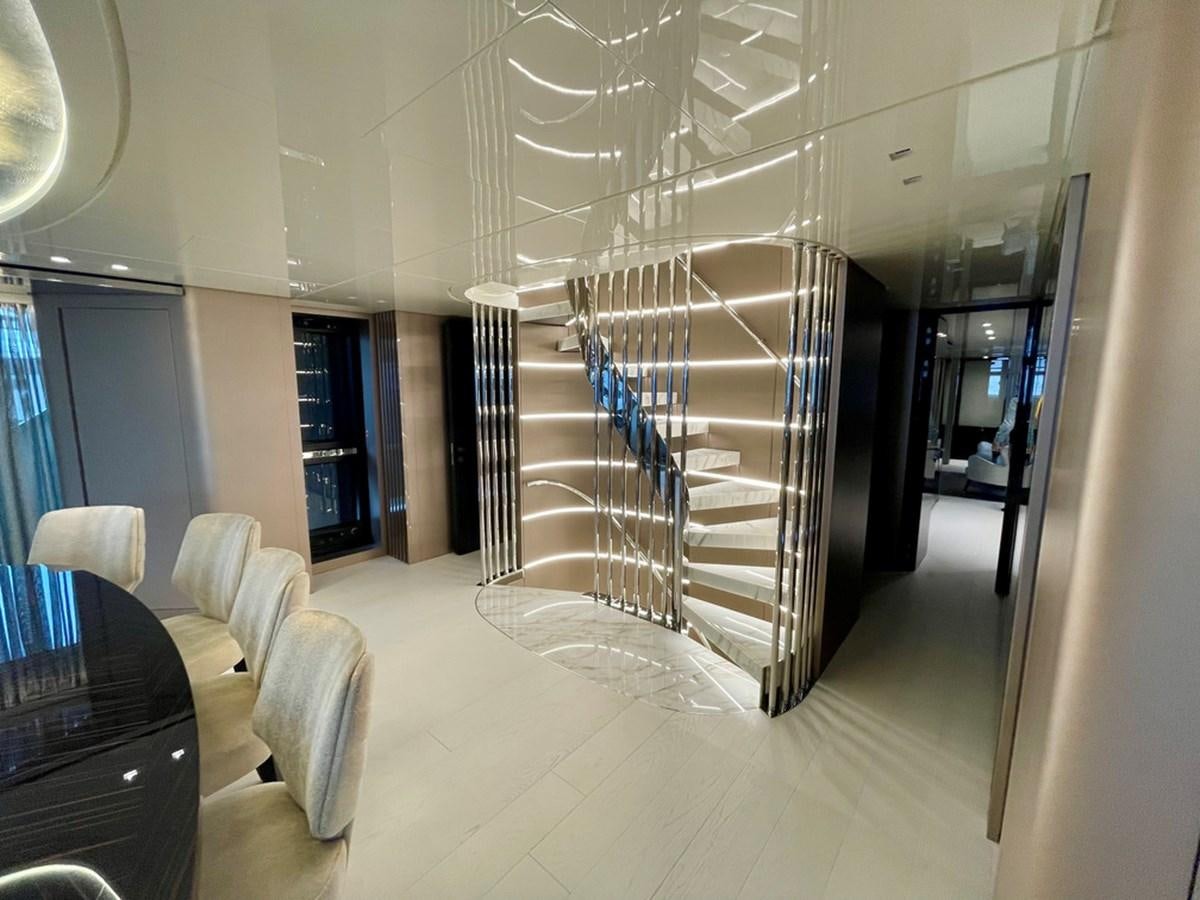 a large room with a staircase and a glass wall aboard TOGETHER Yacht for Sale