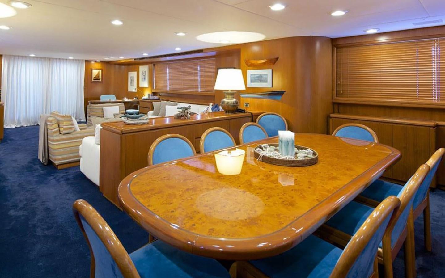 a large dining table in a room aboard AQUAJOY Yacht for Sale
