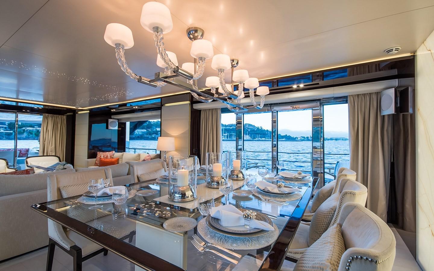 a large dining room with a large chandelier aboard SOULMATE Yacht for Sale