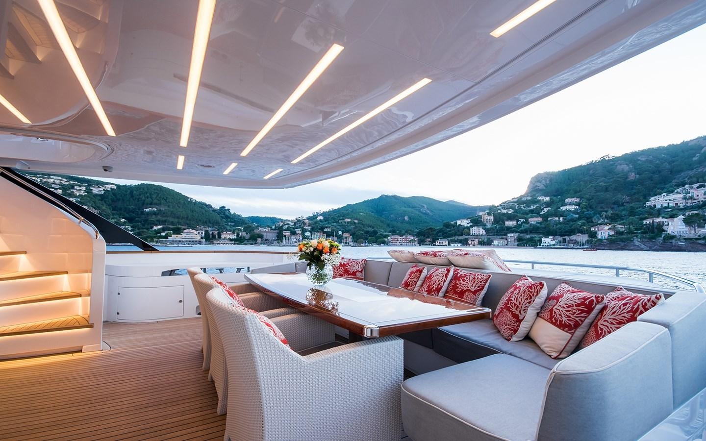 a room with a couch and a table with flowers on it aboard SOULMATE Yacht for Sale