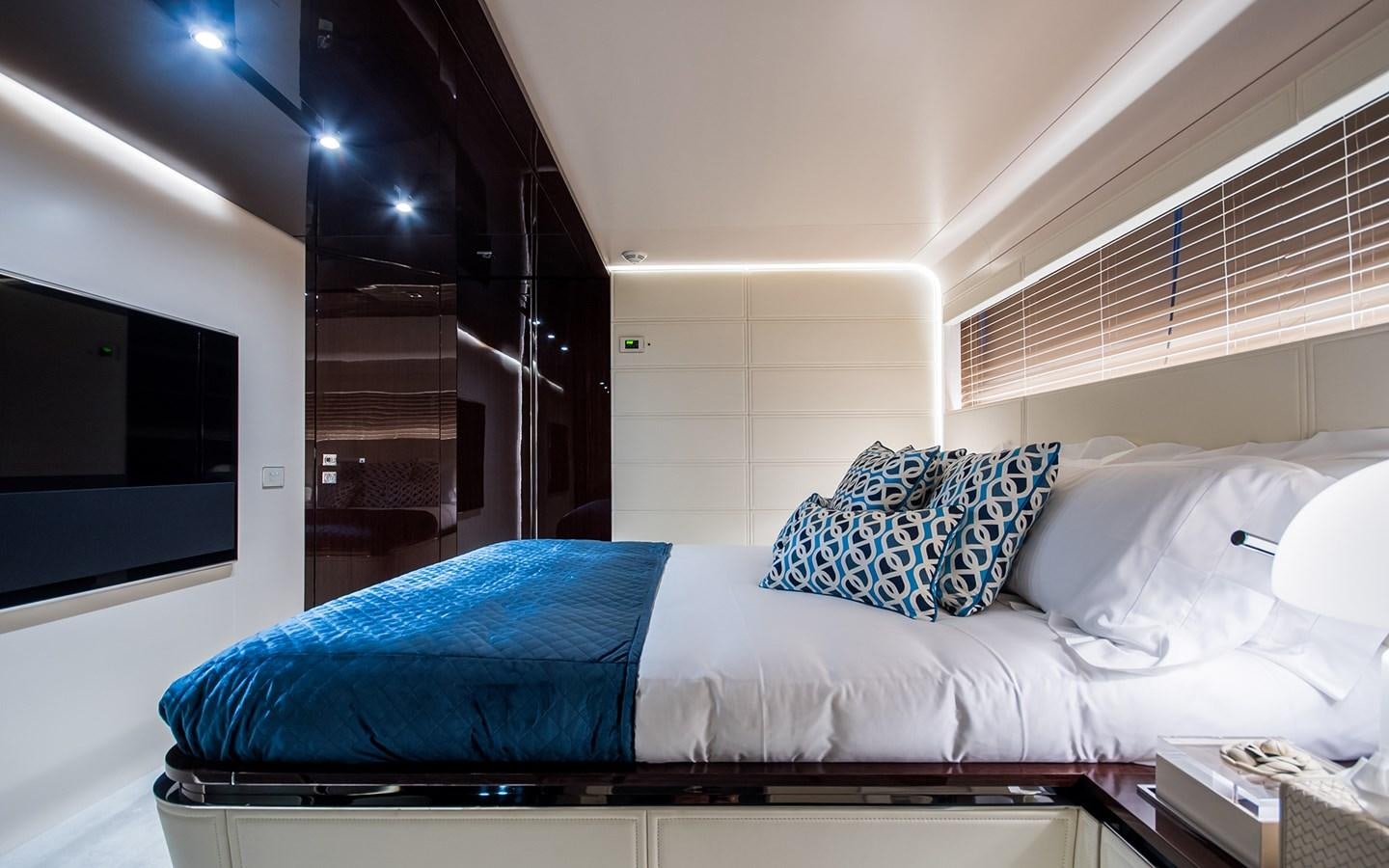 a bed with blue and white pillows aboard SOULMATE Yacht for Sale