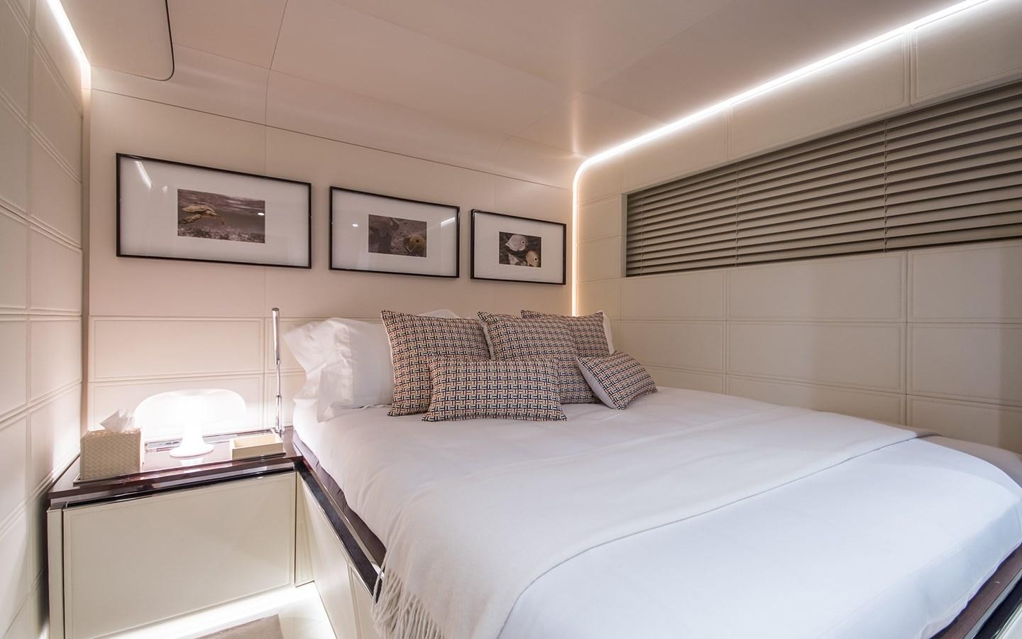 a bed with a white bed spread aboard SOULMATE Yacht for Sale