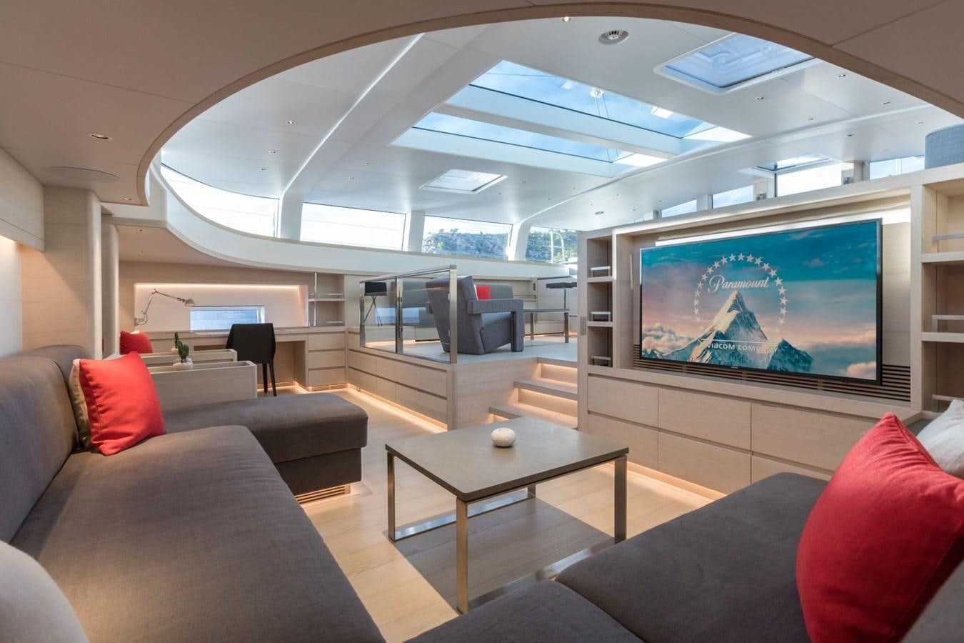 a living room with a large screen aboard CERVO Yacht for Sale