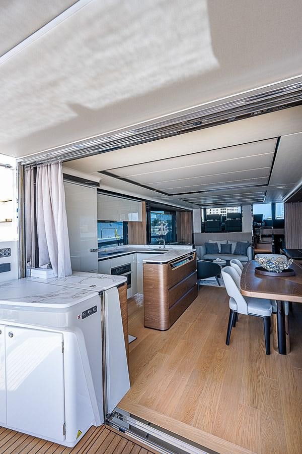 a kitchen with a table and chairs aboard 68 NAVETTA  Yacht for Sale