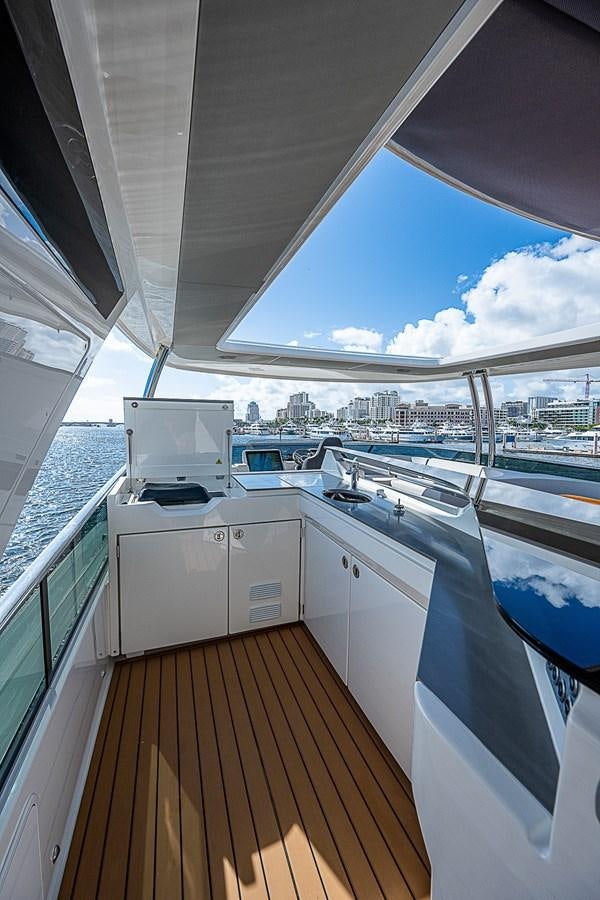 a large open space with a wood deck and a large deck with a large window and a view aboard 68 NAVETTA  Yacht for Sale