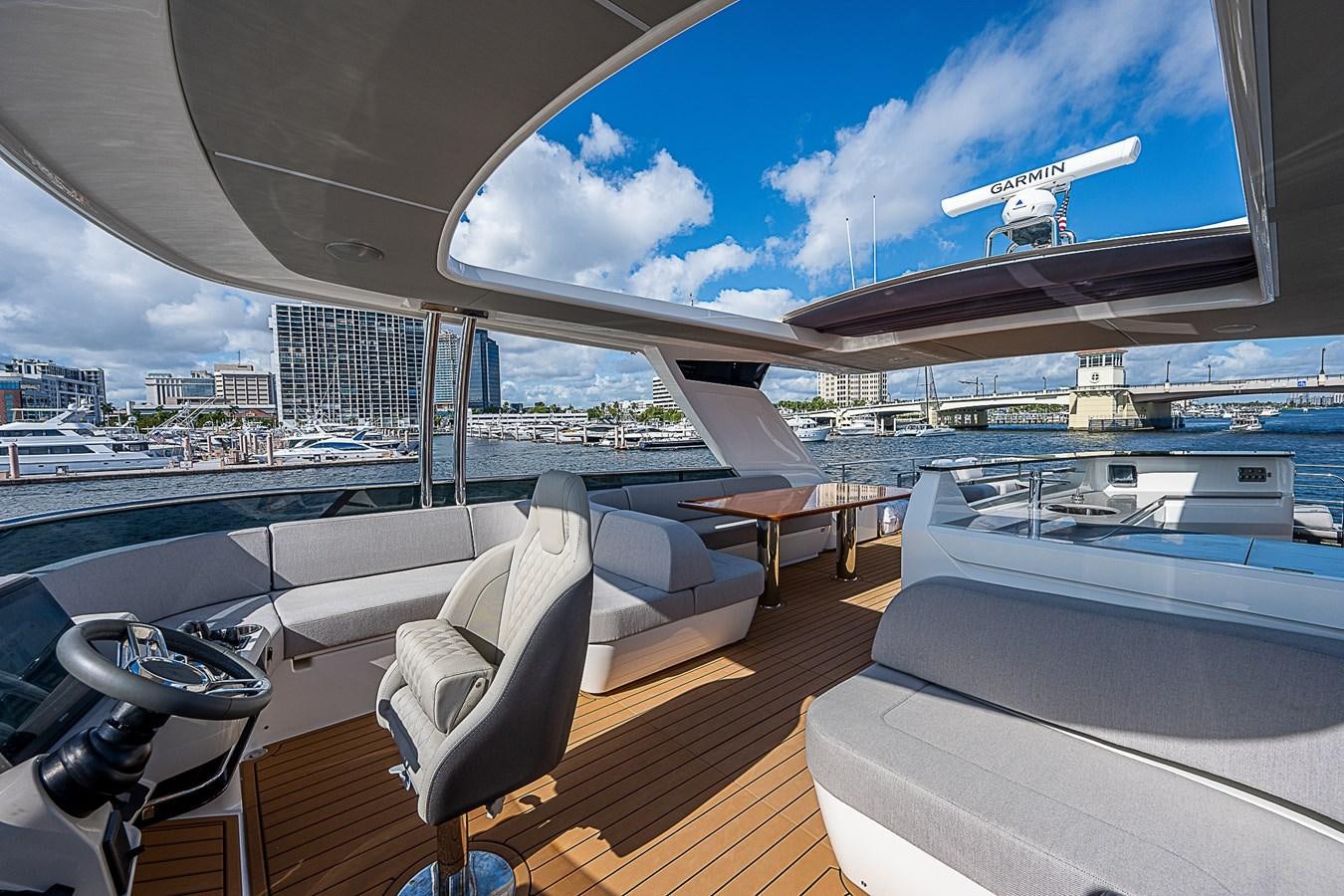 a deck with a view of a city and a plane flying over it aboard 68 NAVETTA  Yacht for Sale