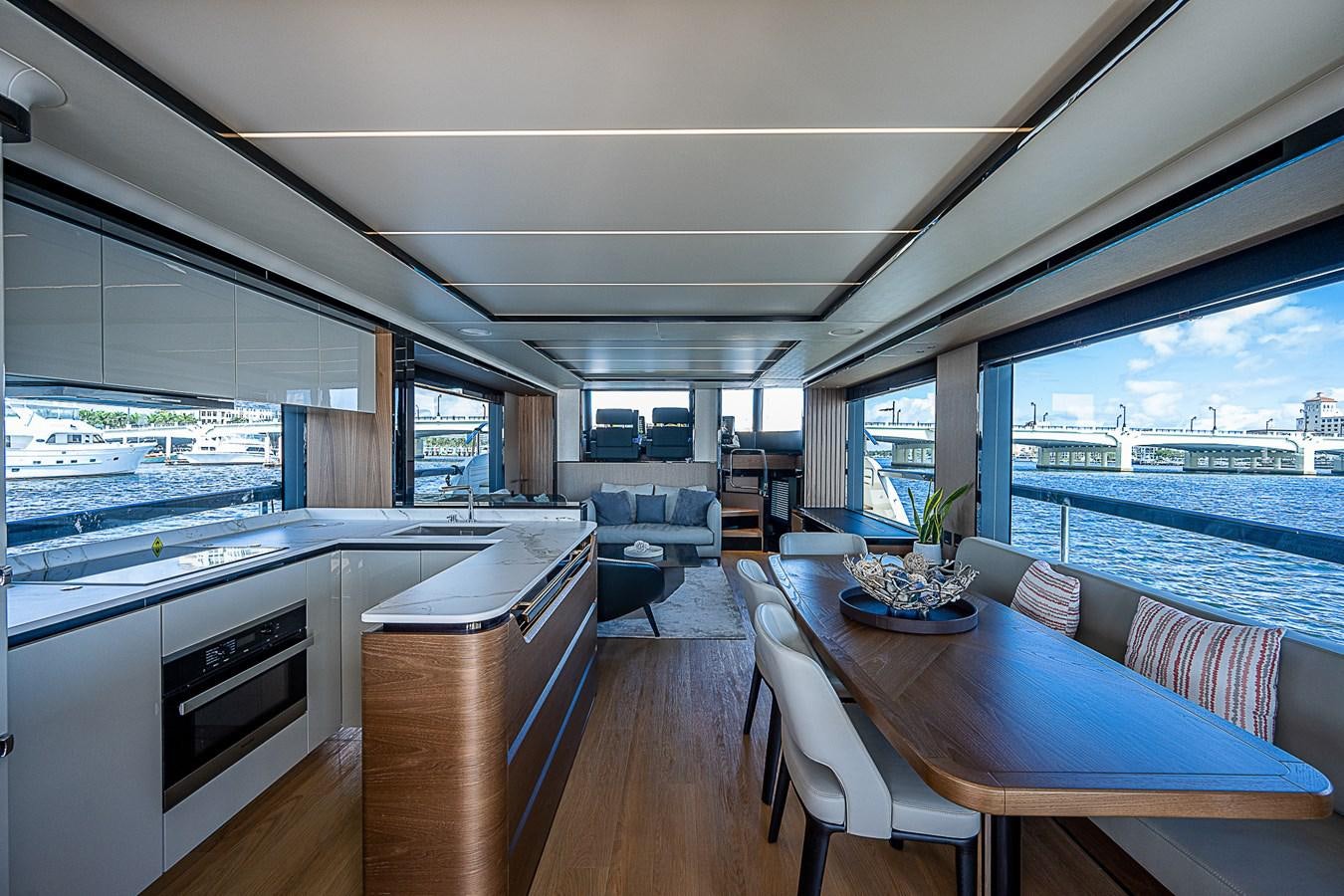 a room with a table chairs and a view of the ocean aboard 68 NAVETTA  Yacht for Sale