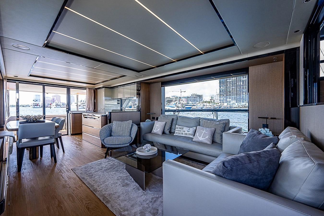 a living room with a large window aboard 68 NAVETTA  Yacht for Sale
