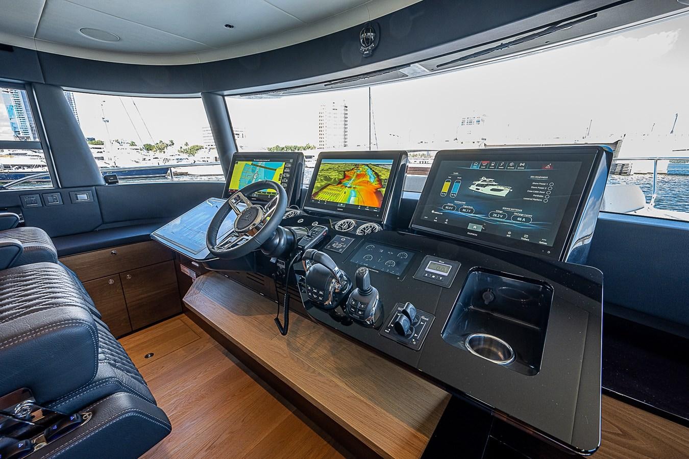a car with a couple of monitors and a couple of laptops on a table aboard 68 NAVETTA  Yacht for Sale