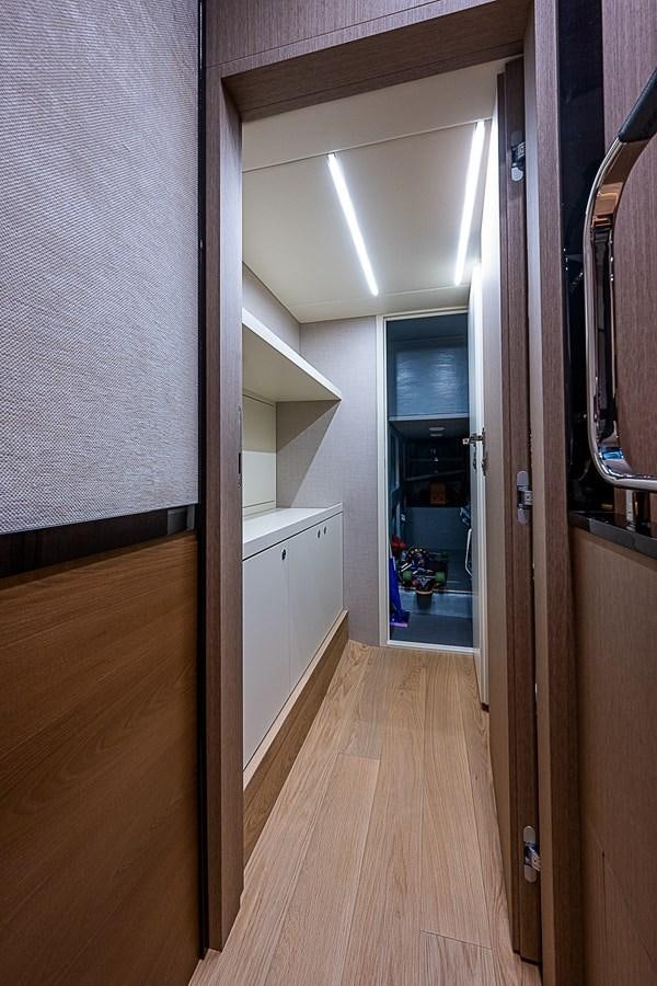a hallway with a door and cabinets aboard 68 NAVETTA  Yacht for Sale