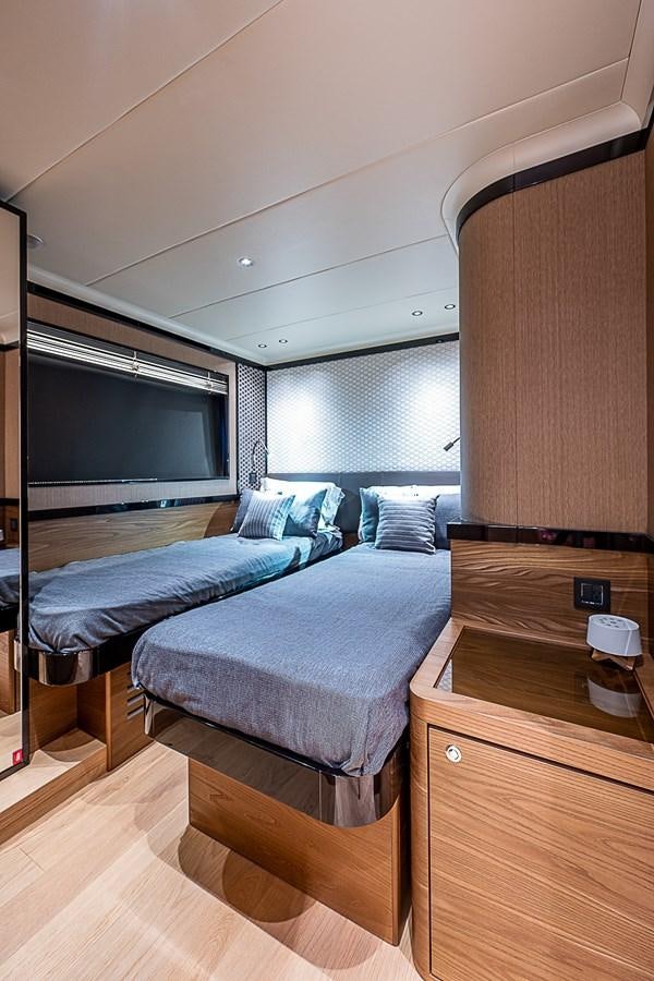 a bedroom with a bed and a tv aboard 68 NAVETTA  Yacht for Sale