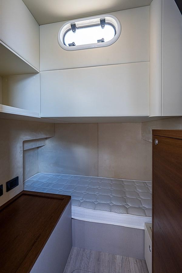 a white kitchen with a tile floor aboard 68 NAVETTA  Yacht for Sale