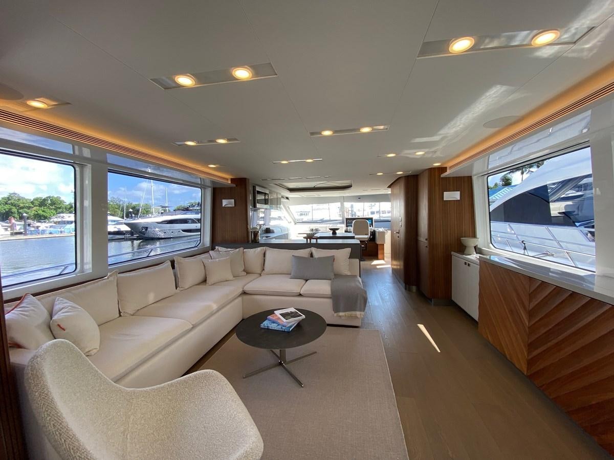 a living room with a large screen aboard CLB72 Yacht for Sale