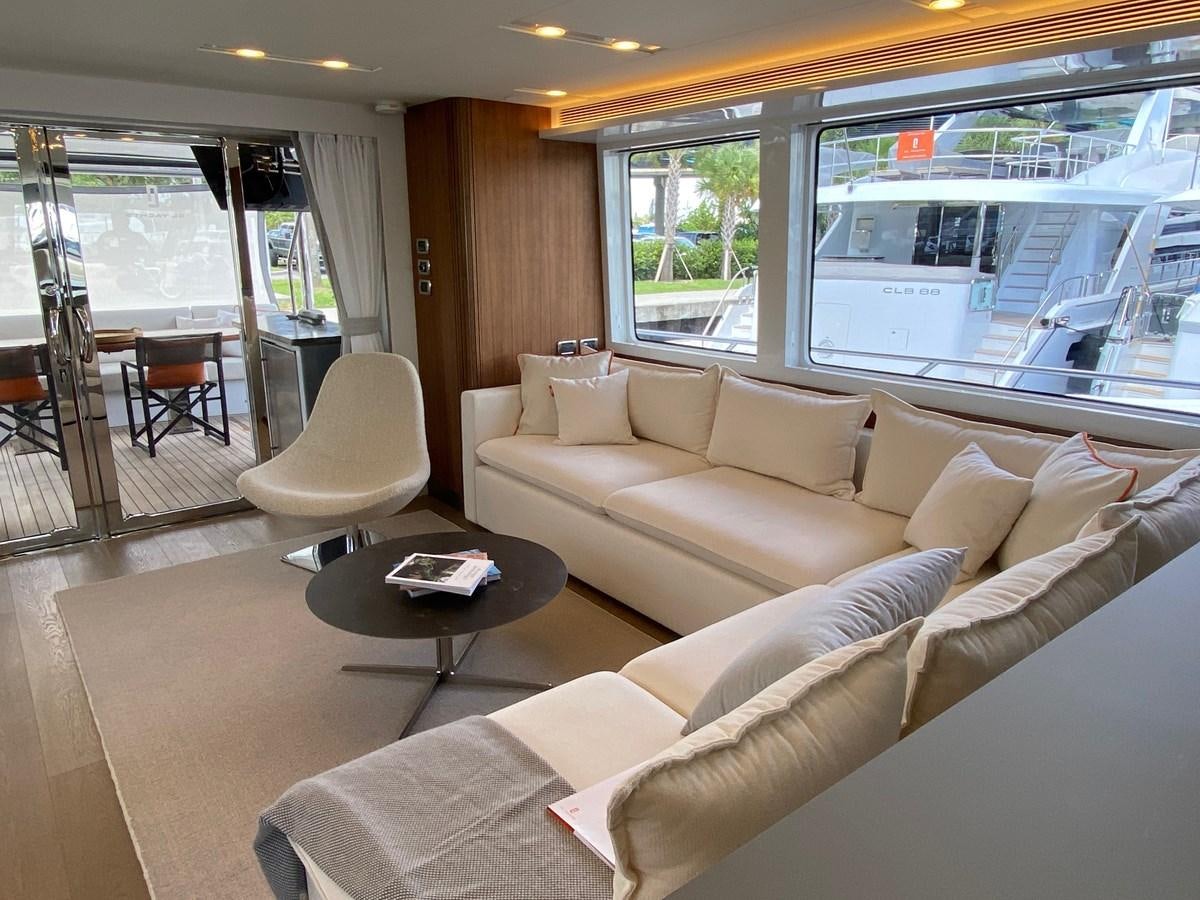 a living room with a couch and a coffee table aboard CLB72 Yacht for Sale