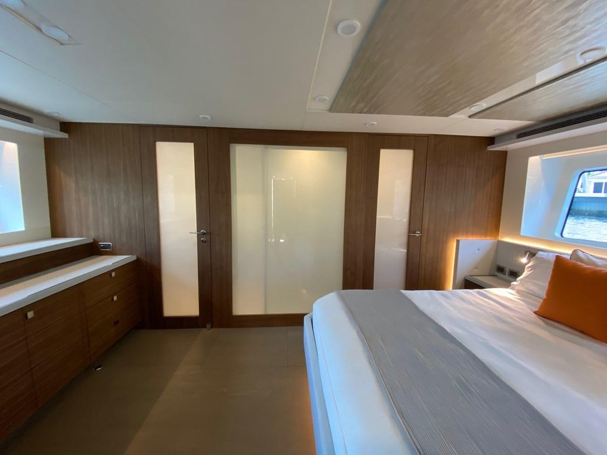 a room with a bed and a closet aboard CLB72 Yacht for Sale