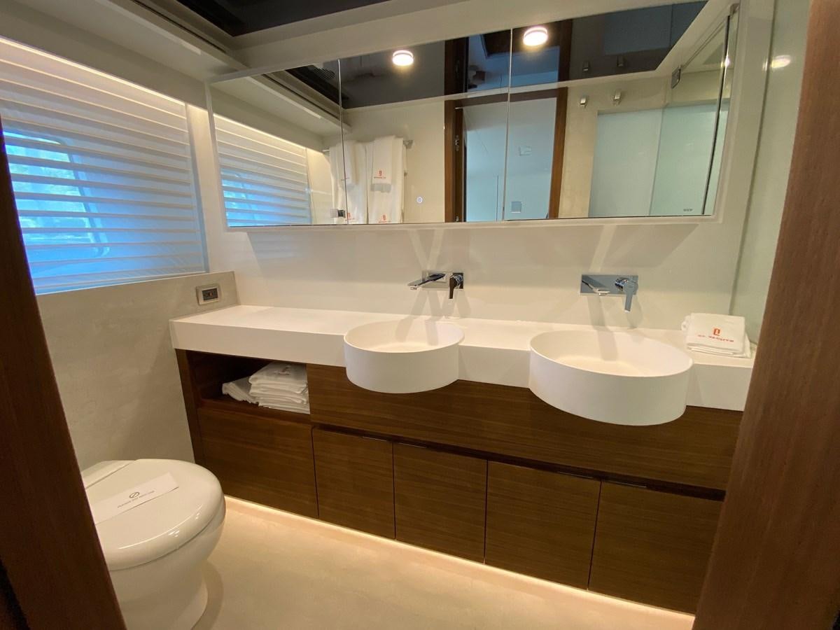 a bathroom with a large mirror aboard CLB72 Yacht for Sale