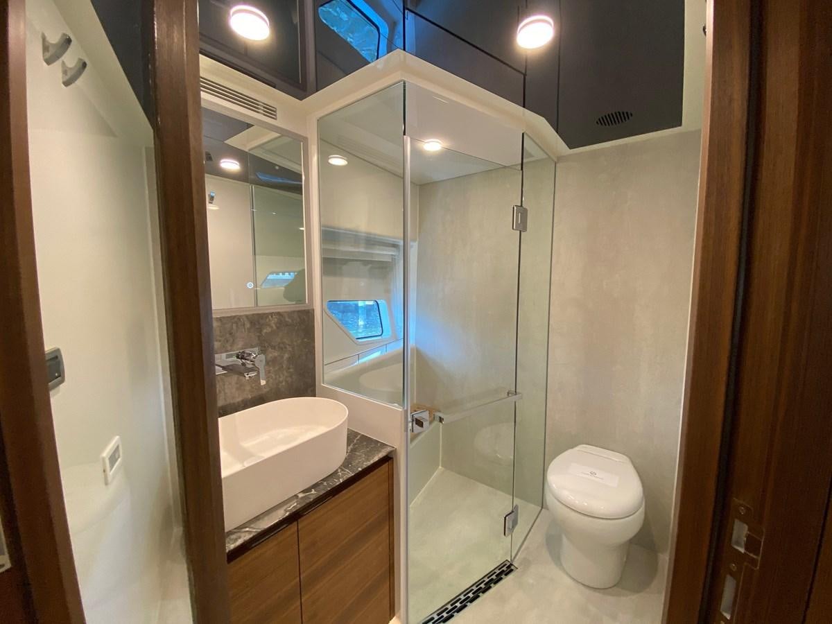 a bathroom with a glass shower aboard CLB72 Yacht for Sale