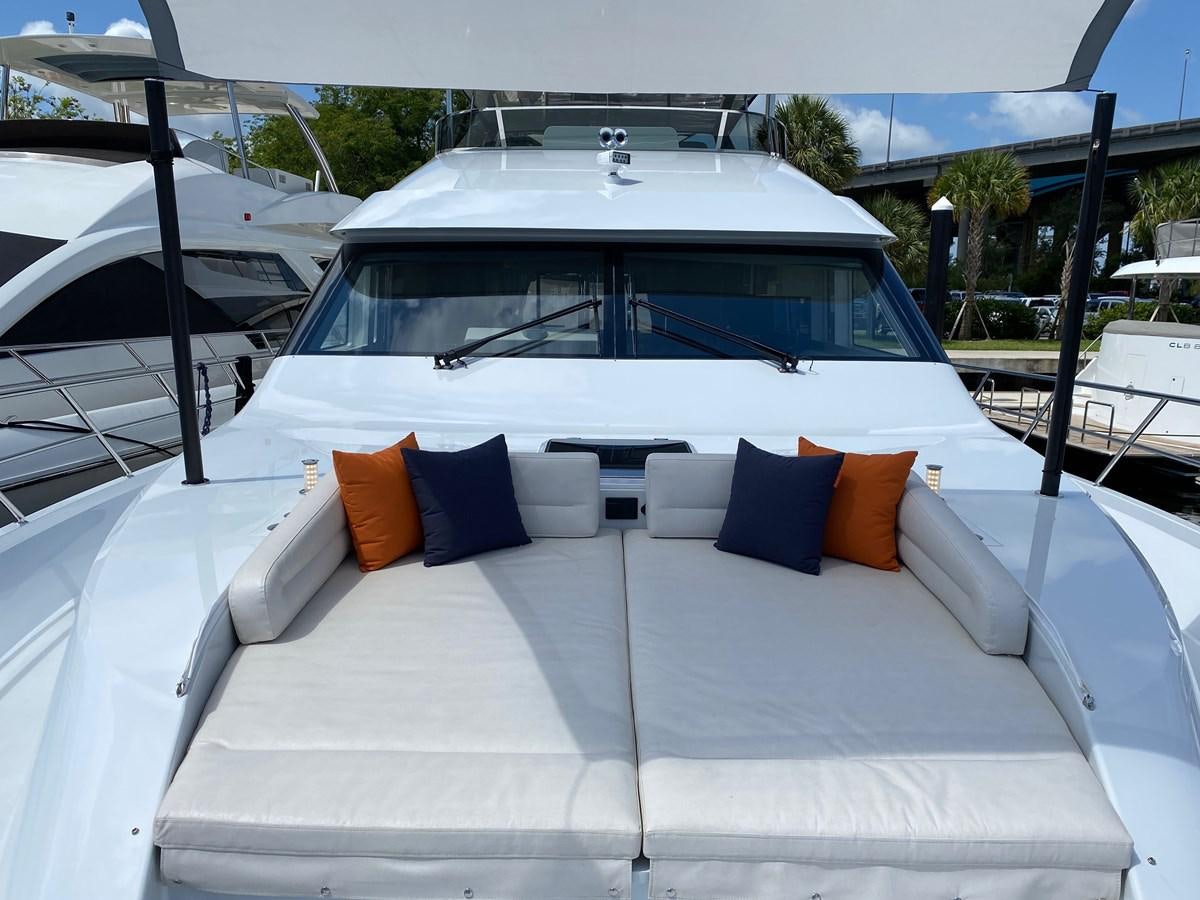 a white car with orange pillows aboard CLB72 Yacht for Sale
