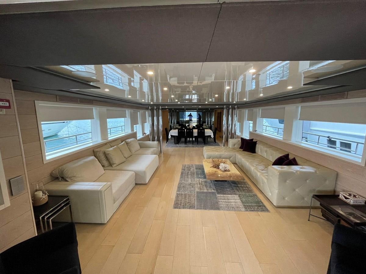 a room with a couch and a table aboard AQUILA Yacht for Sale
