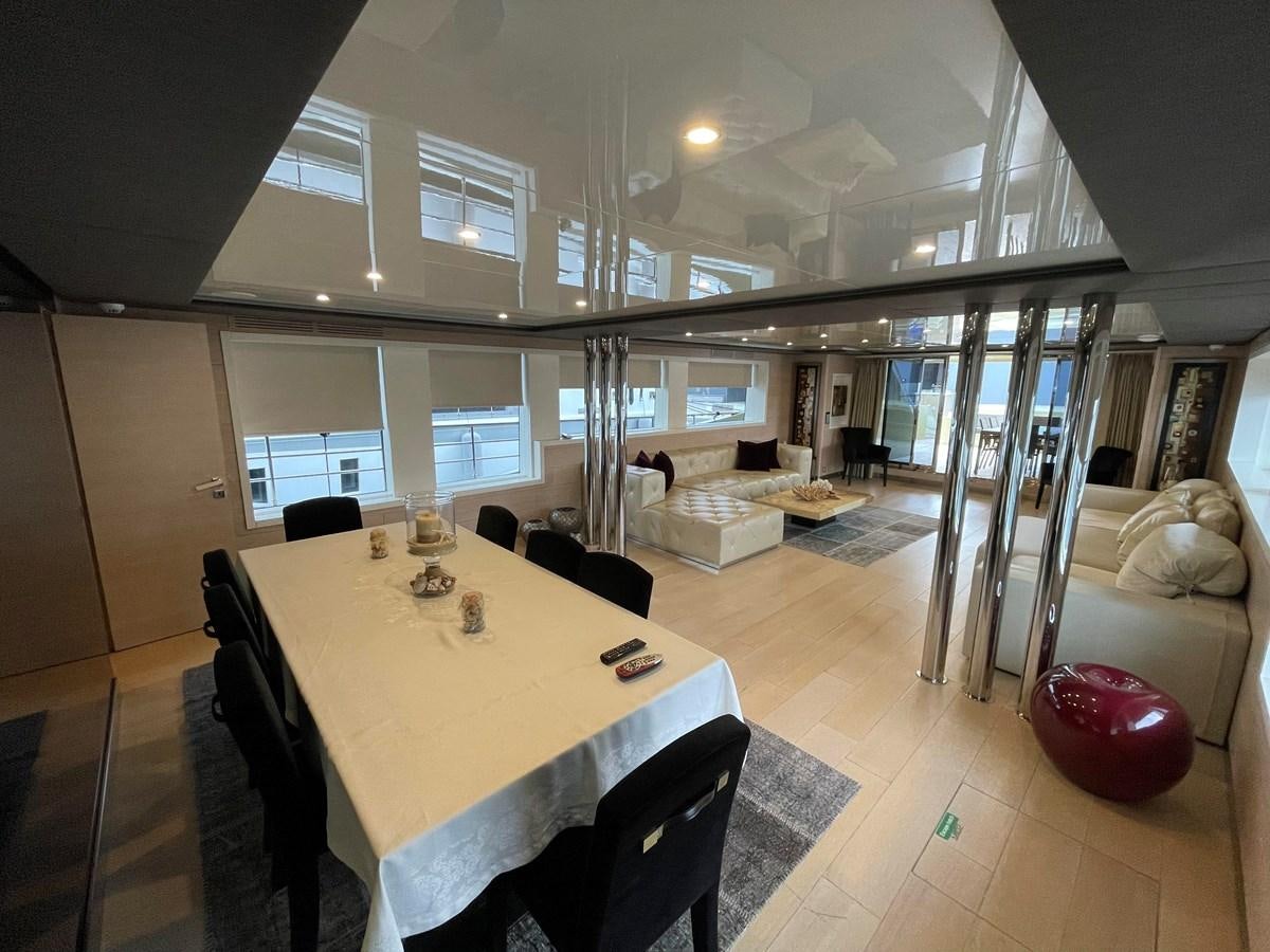 a dining table in a room aboard AQUILA Yacht for Sale