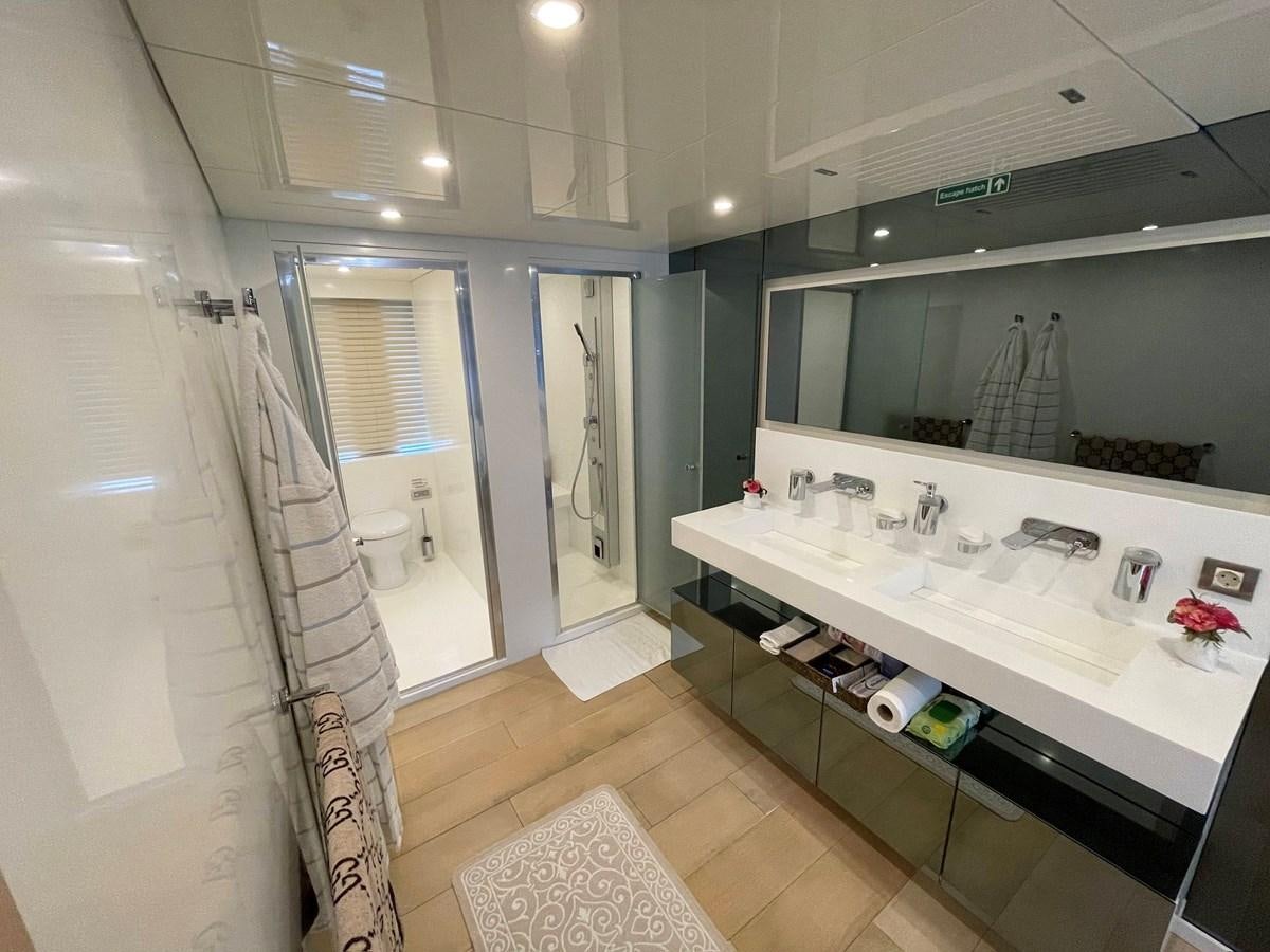 a bathroom with a countertop sink and mirror aboard AQUILA Yacht for Sale