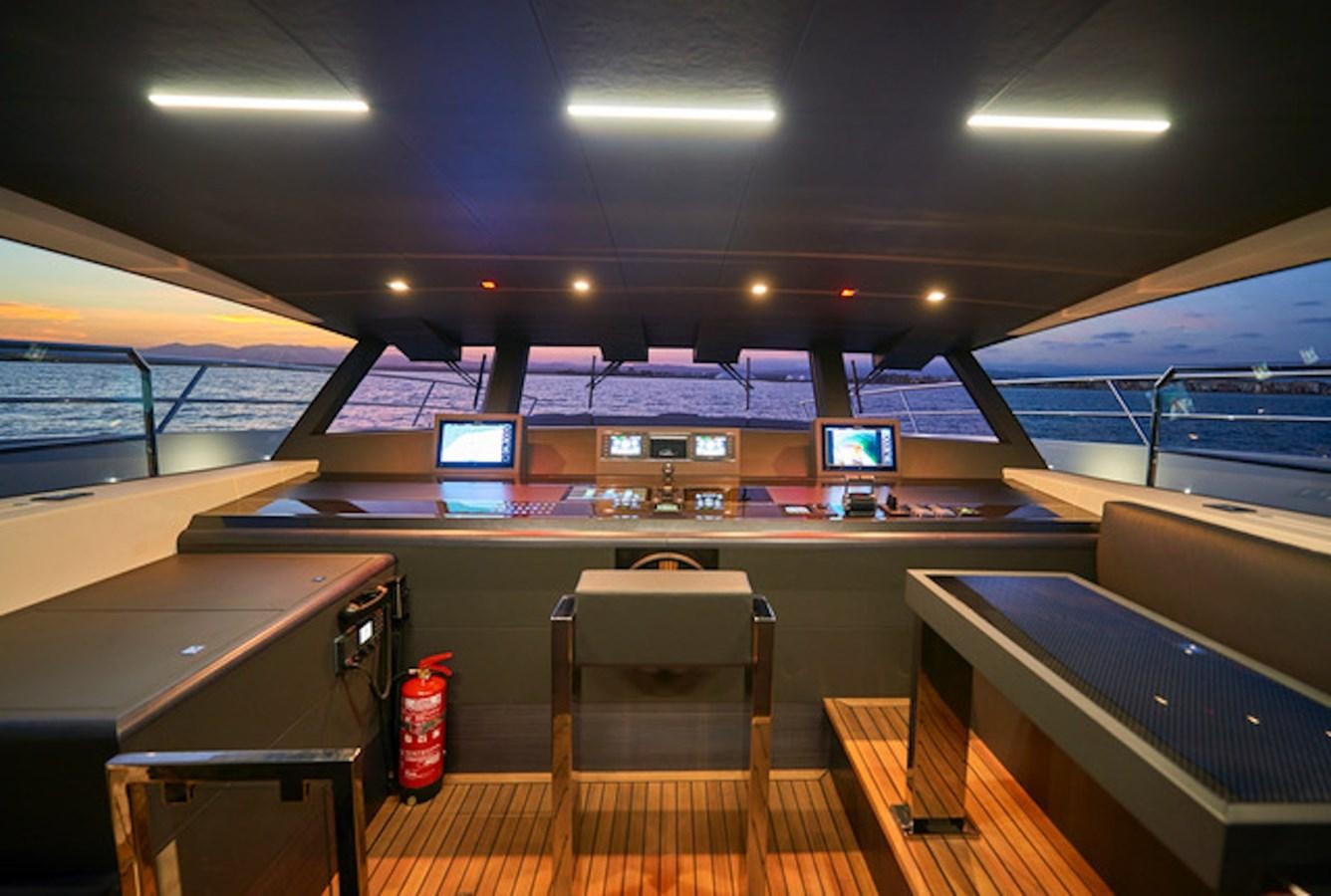 a room with a table and chairs aboard NINITAS Yacht for Sale