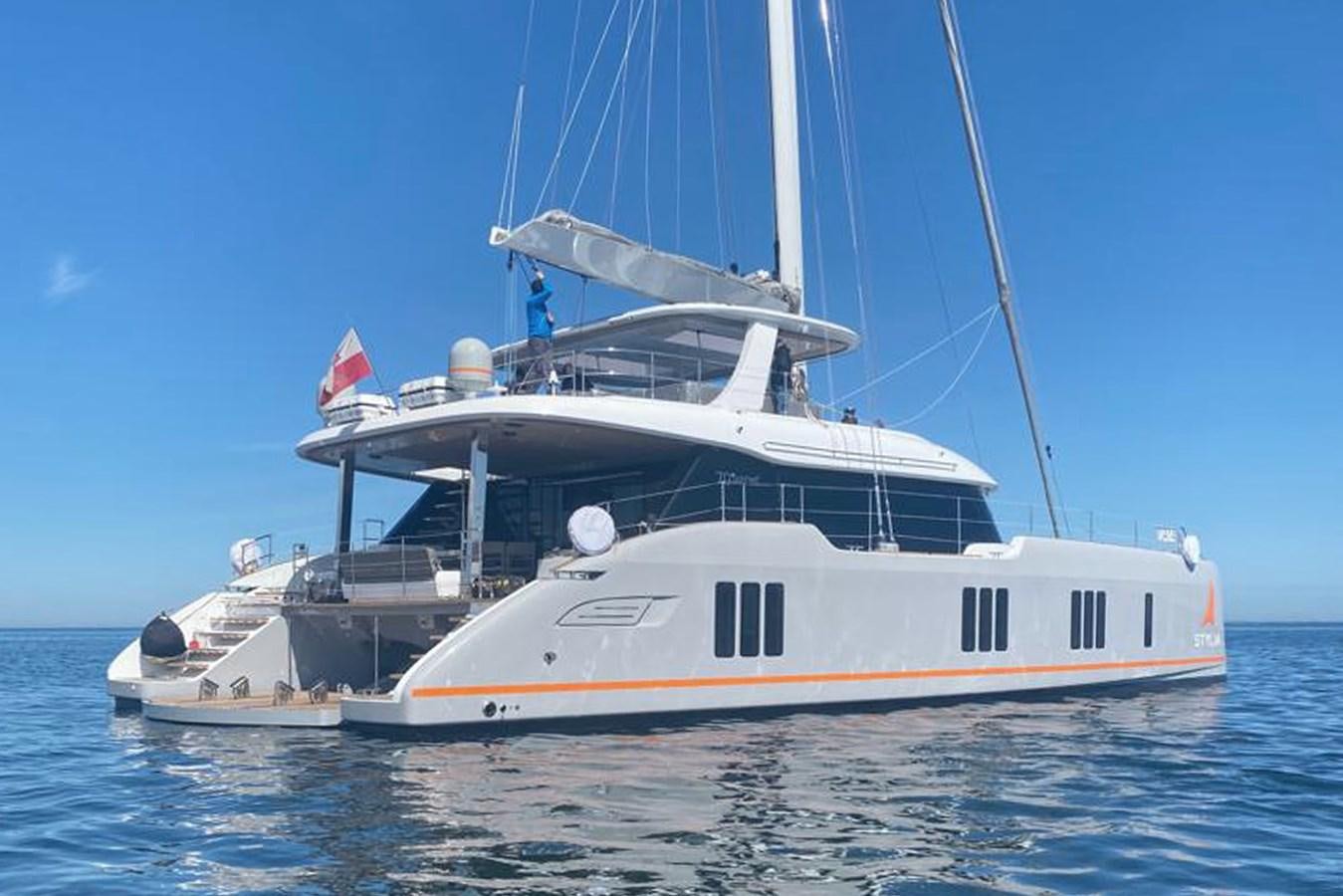 a large white boat in the water aboard STYLIA Yacht for Sale